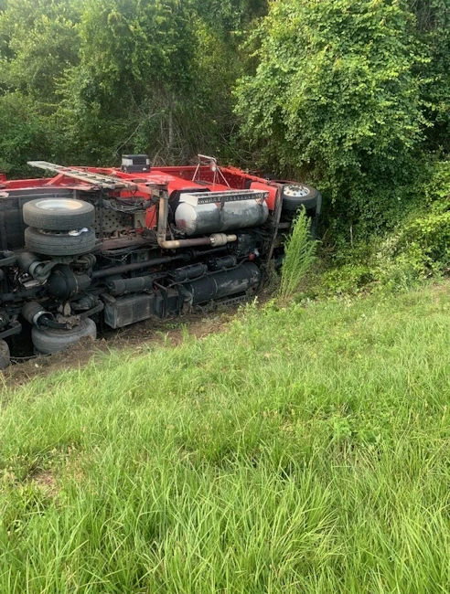 An overturned loaded car hauler that we recovered out of the ditch.